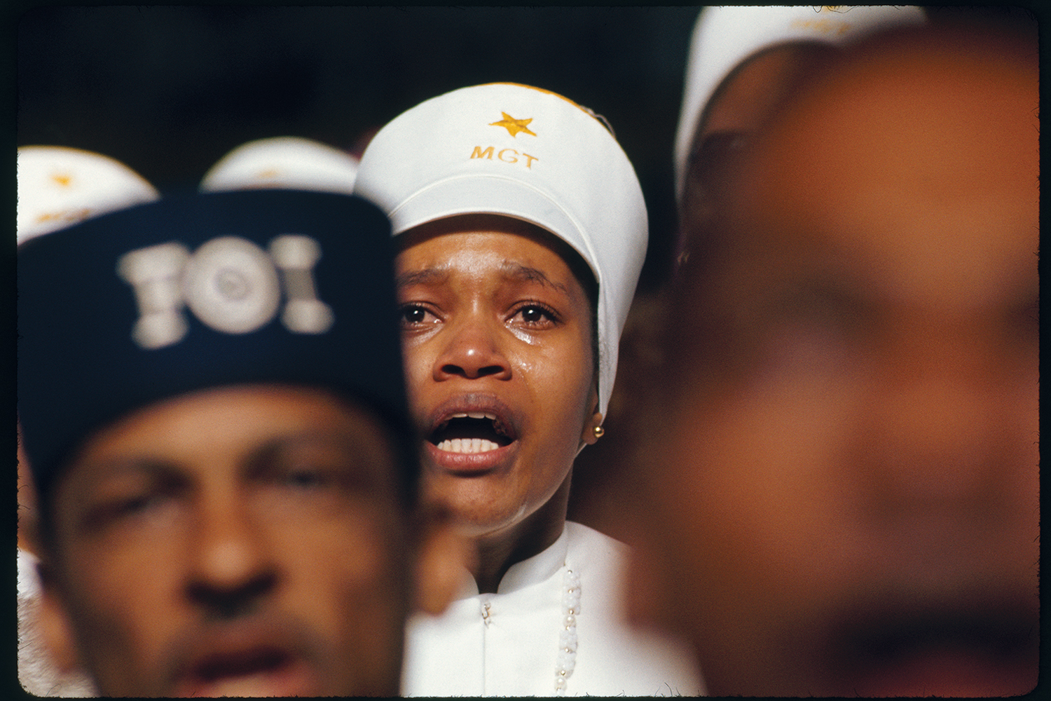 Religious fervor is mirrored in the face of a Black Muslim woman listening to Elijah Muhammad deliver his annual Savior's Day message in Chicago, Illinois, 1974.