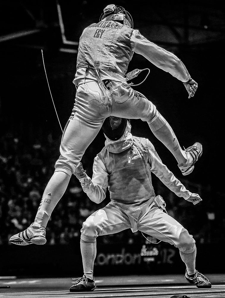 2nd Prize Sports – Sports Action Stories. Sergei Ilnitsky, Russia. 31 July 2012, London, United Kingdom. Alaaeldin Abouelkassem of Egypt (top) in action against Peter Joppich of Germany during their Men's Foil Individual Round 16 match. Years of training, thousands of battles, and hundreds of victories prepared fencing competitors for the opportunity to stand on the piste at the 2012 London Olympic Games to fight for gold.