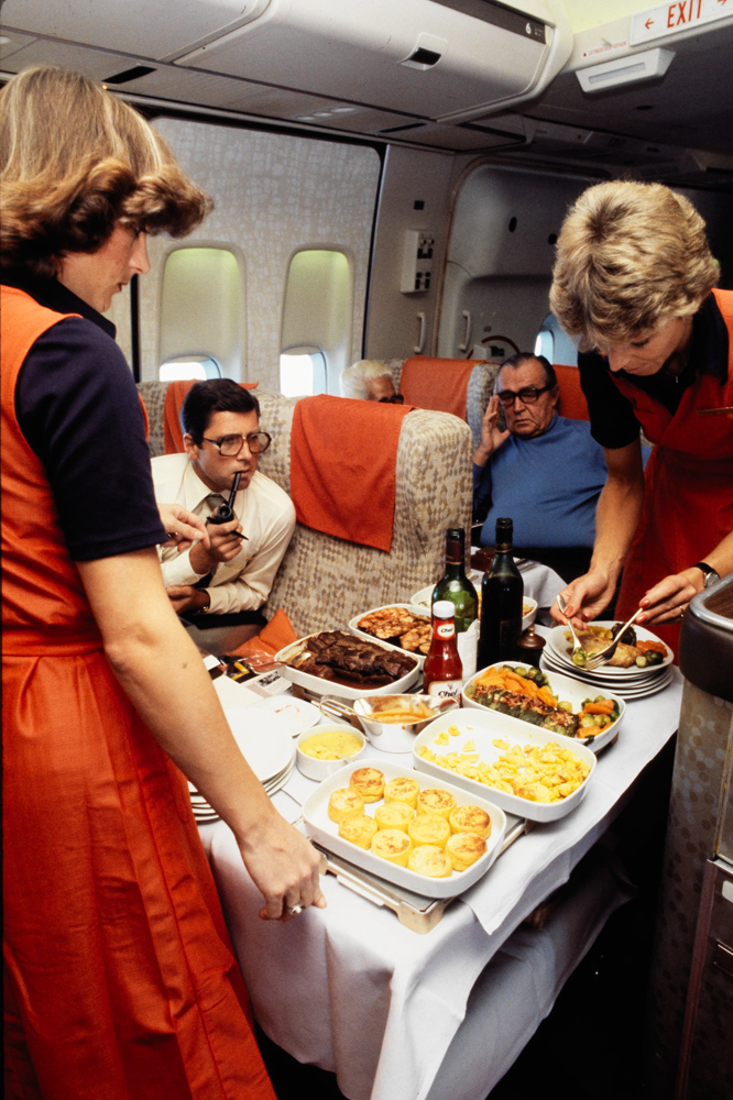 Hostesses serving a meal in a Boeing 747-257 B  (Jumbo), ca. 1978.