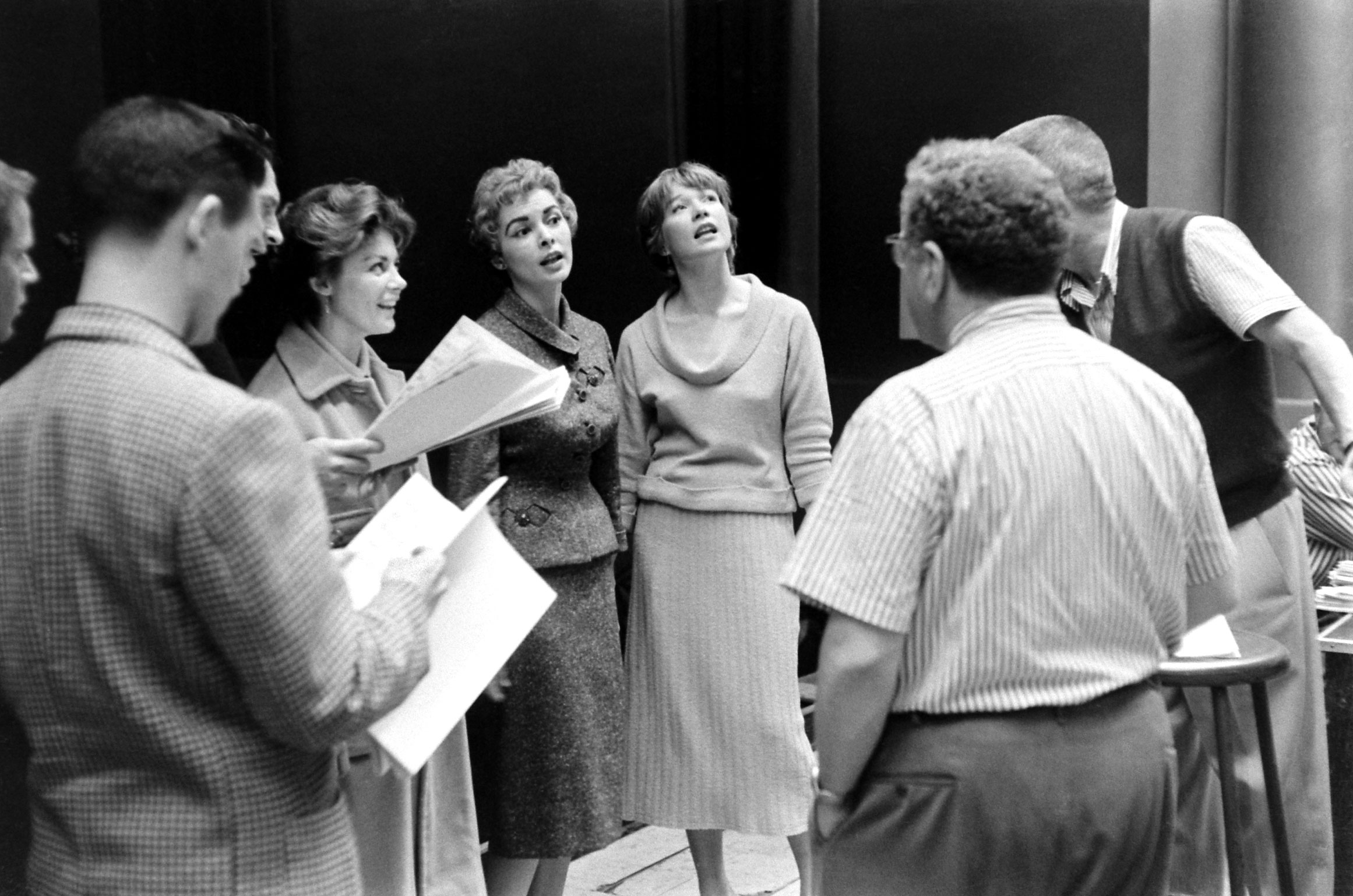 Inside Los Angeles' RKO Pantages theater, home of the Academy Awards from 1949 through 1959, Janet Leigh and Shirley MacLaine practice a tune.