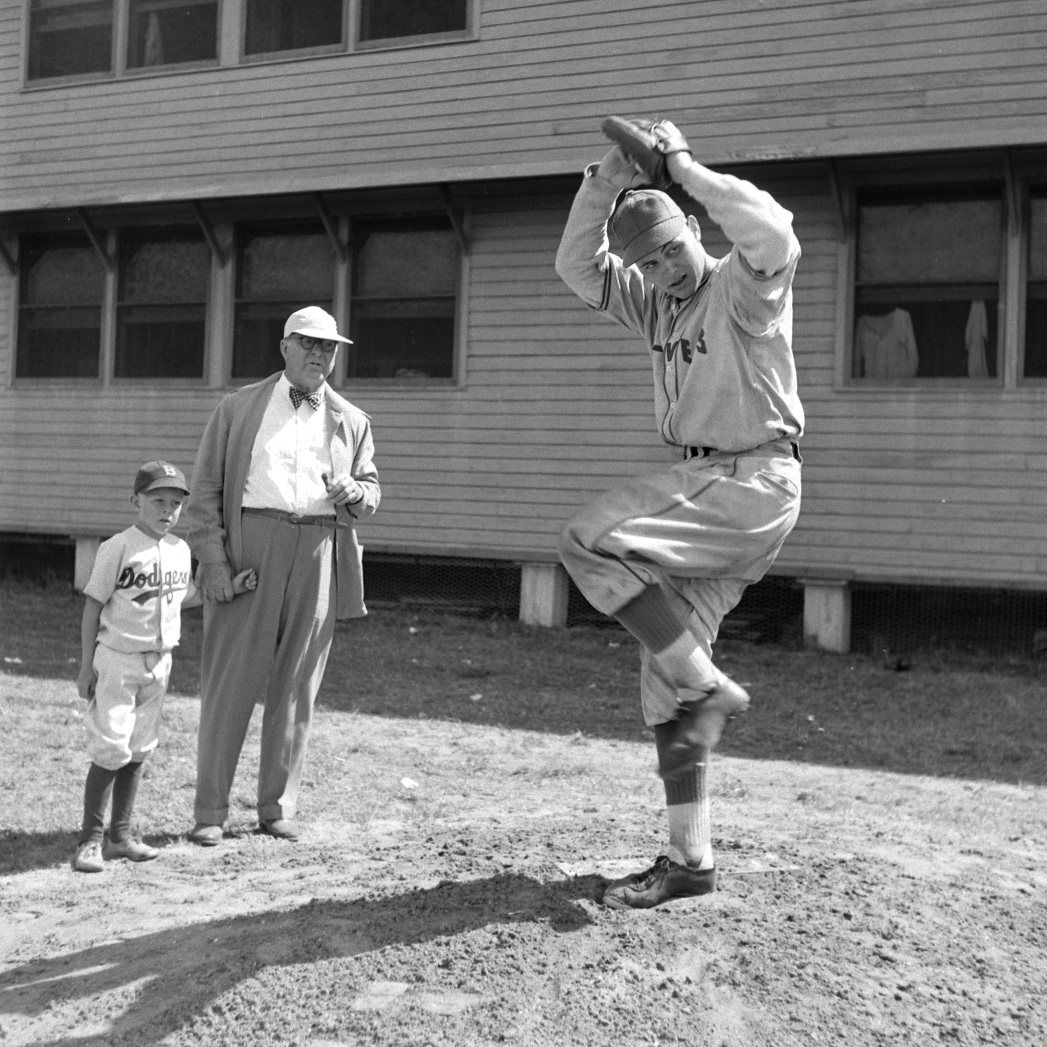 The great Dodgers general manager Branch Rickey and his grandson watch a pitcher go through his wind-up, Vero Beach, Fla., 1948.