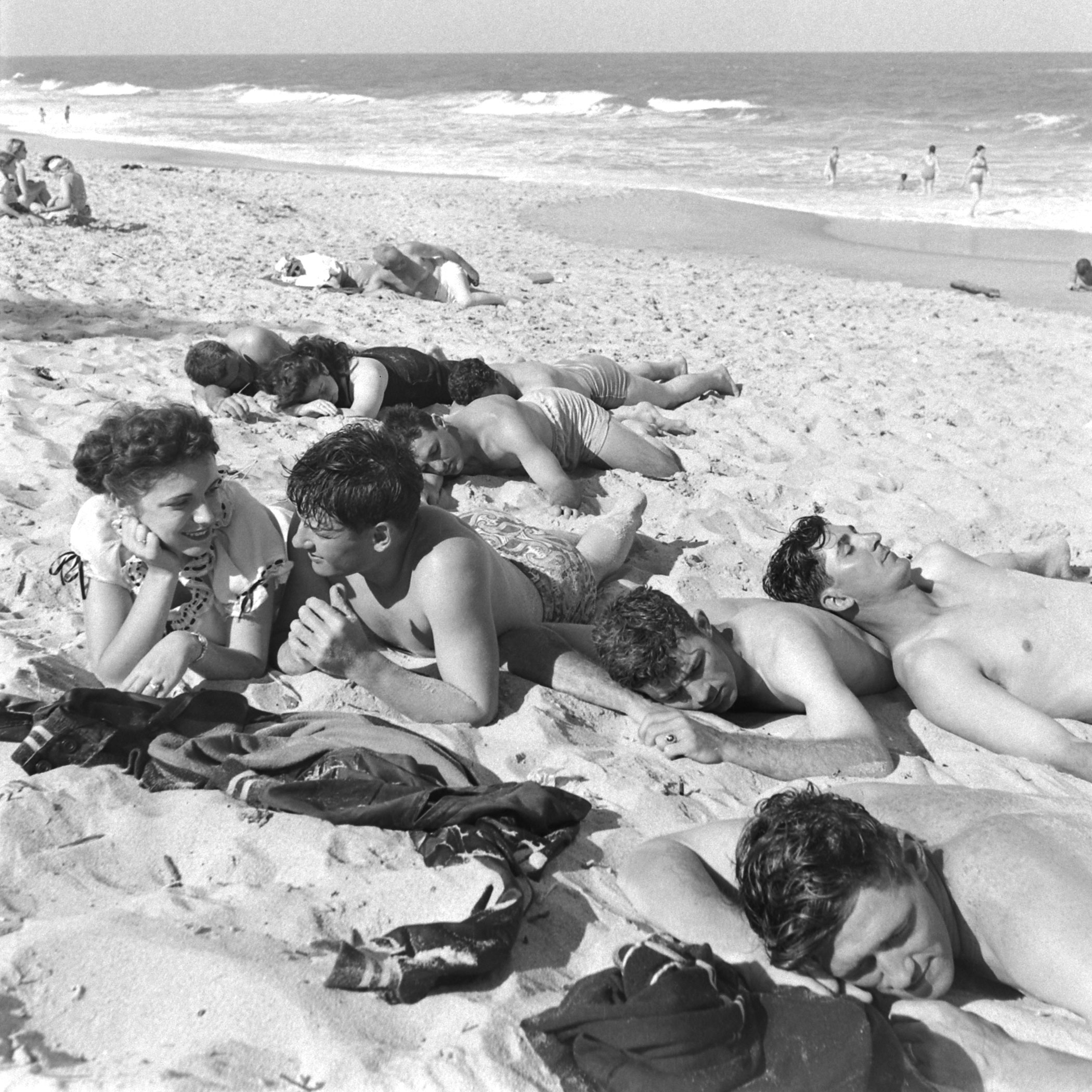 Brooklyn Dodgers and young women relax on the beach during spring training at Dodgertown, Vero Beach, Fla., 1948.