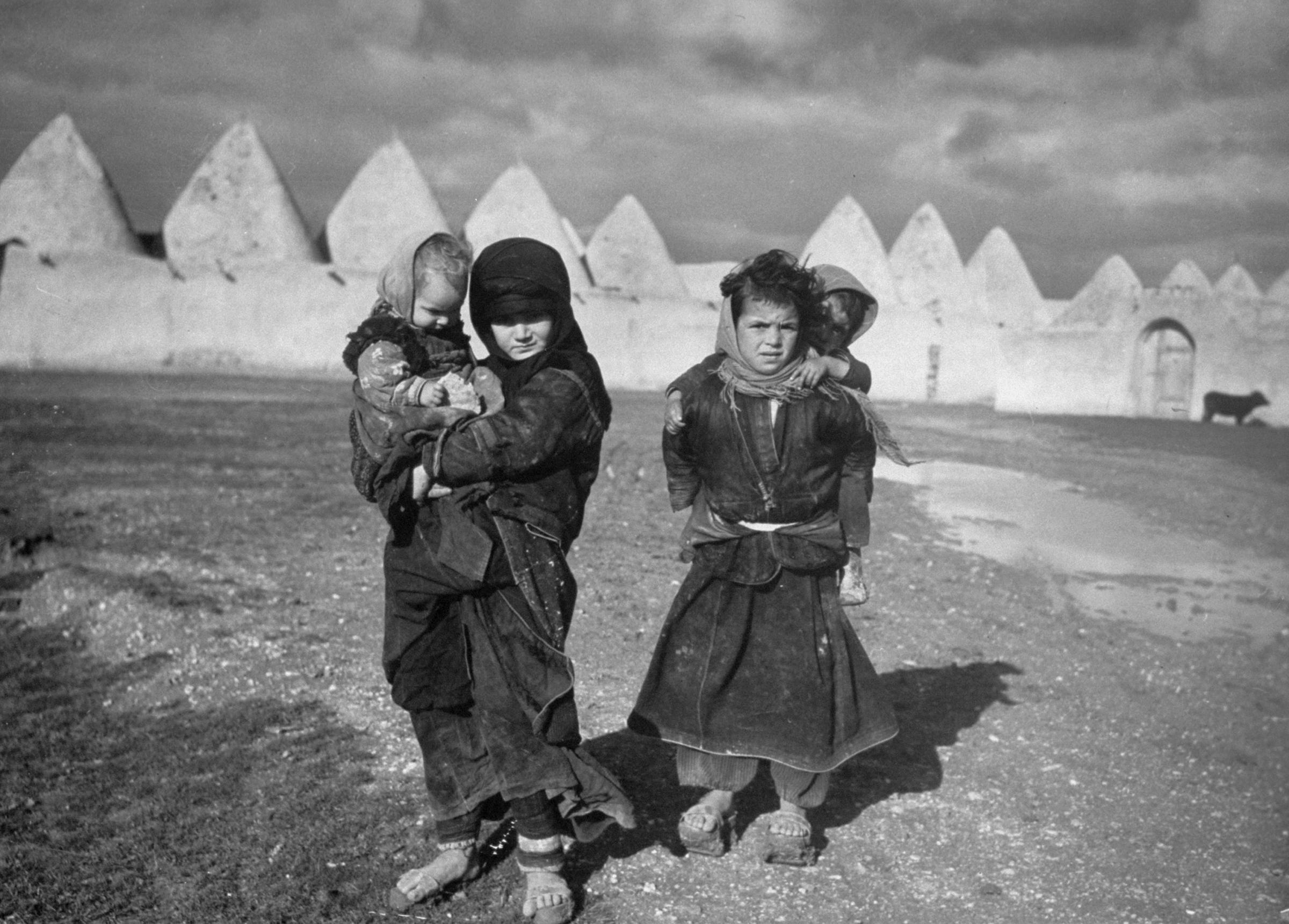 Syrian children outside the walled town of Tell Bisse, Syria, 1940.