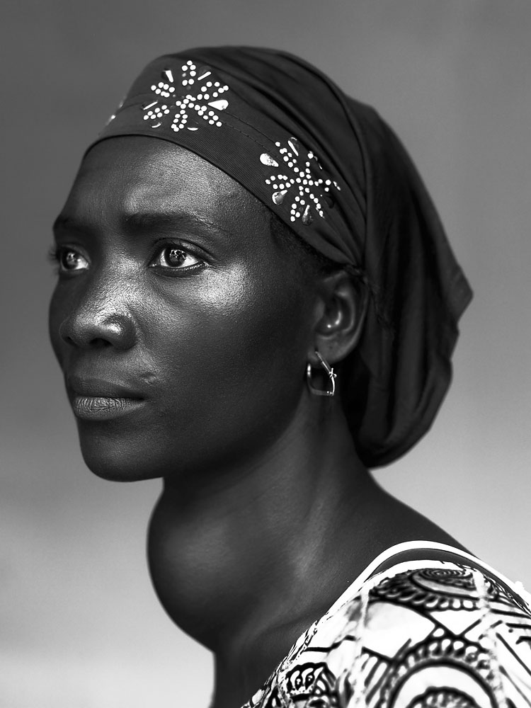 1st Prize People – Staged Portraits Stories. Stephan Vanfleteren, Belgium. 17 October 2012, Conakry, Guinea. Makone Soumaoro, 30, goiter. “I don't have pain, but I am worried that my neck swells that much. I hope it it is not a tumor because I am a housewife and my man and three children need me.” Guinea is one of the least developed countries in the world. More than 60 percent of the population lives on less than one dollar per day. Three quarters of the population is illiterate. Health care is substandard and unaffordable for most people. Some get help with their health problems from NGO Mercy Ships aboard the hospital ship 'African Mercy' docked in the capital Conakry. They are treated by volunteer surgeons, doctors and nurses with such health issues as cataracts, teeth problems, and skin diseases to more complex orthopedic or tumor surgeries. Guinea is one of the least developed countries in the world.More than 60% live below the poverty line of $ 1 per day. Three quarters of the population is illiterate. Health care is substandard and priceless for most of the people.These portraits are from people with different kind of diseases who will maybe be helped or been helped by the Ngo Mercy Ships on the hospital ship ‘African Mercy’, that is docked in the capital Conakry. From simple operations as cataract, teeth problems, skin diseases to more delicate orthopaedic or tumor surgery are operated by surgeons , doctors and caring nurses who work voluntary on the hospital ship. Specified text Makone Soumaoro, 30 years, goitre ‘I don’t have pain, but I am worried that my neck swells that much.I hope that it is not a tumor, because I am a housewife and my man and three children need me.’