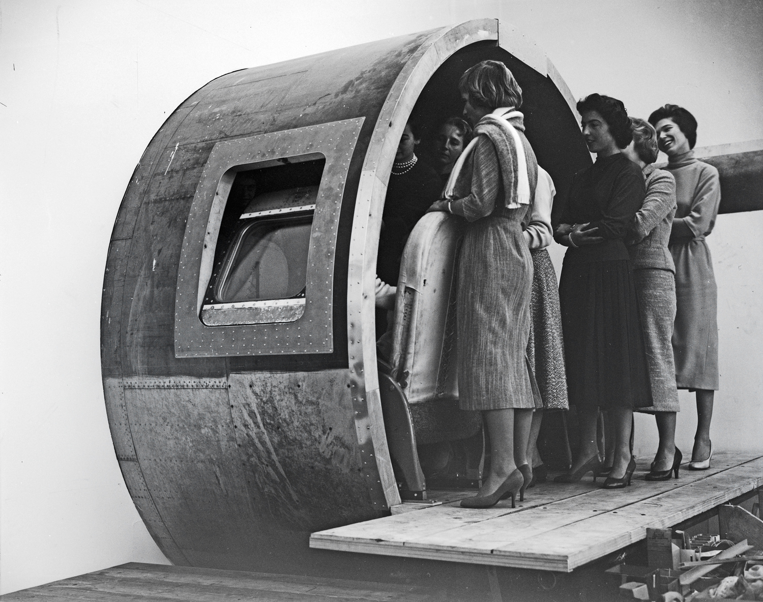 Training center and course for hostesses: seat adjustment in a mock-up of the DC-7C, 1957.