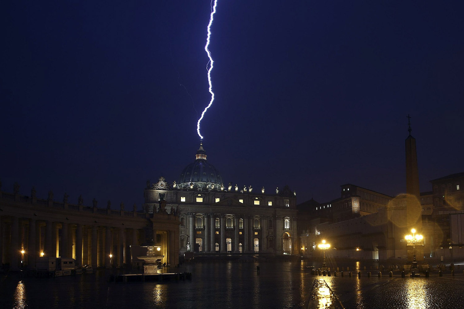 A flash of lighting is seen over St.Peter's Basilica during a rainstorm at Vatican