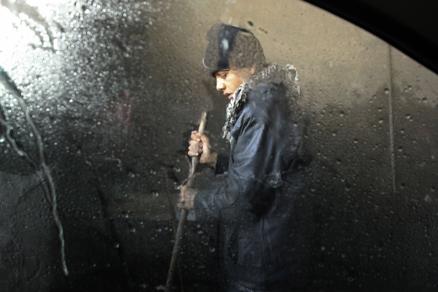 Feb. 27, 2013. A boy works at a car wash in Aleppo, Syria.