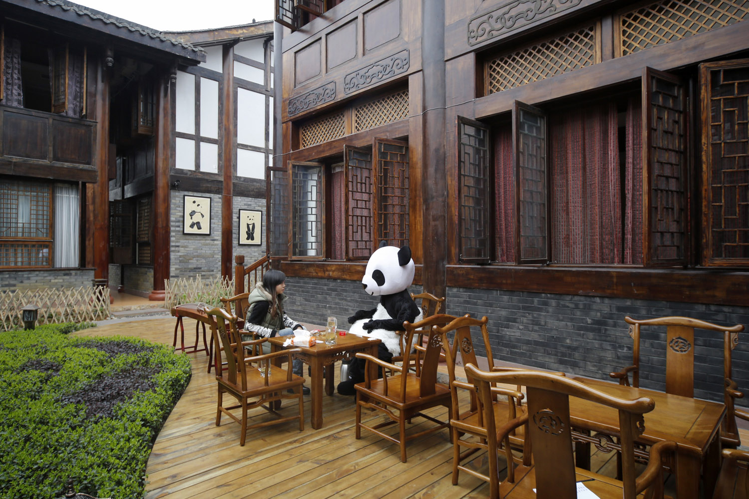 Feb. 22, 2013. An employee wears a panda suit while talking to a woman at a panda-themed hotel at the foot of Emei Mountain in Emeishan, southwest China's Sichuan province.