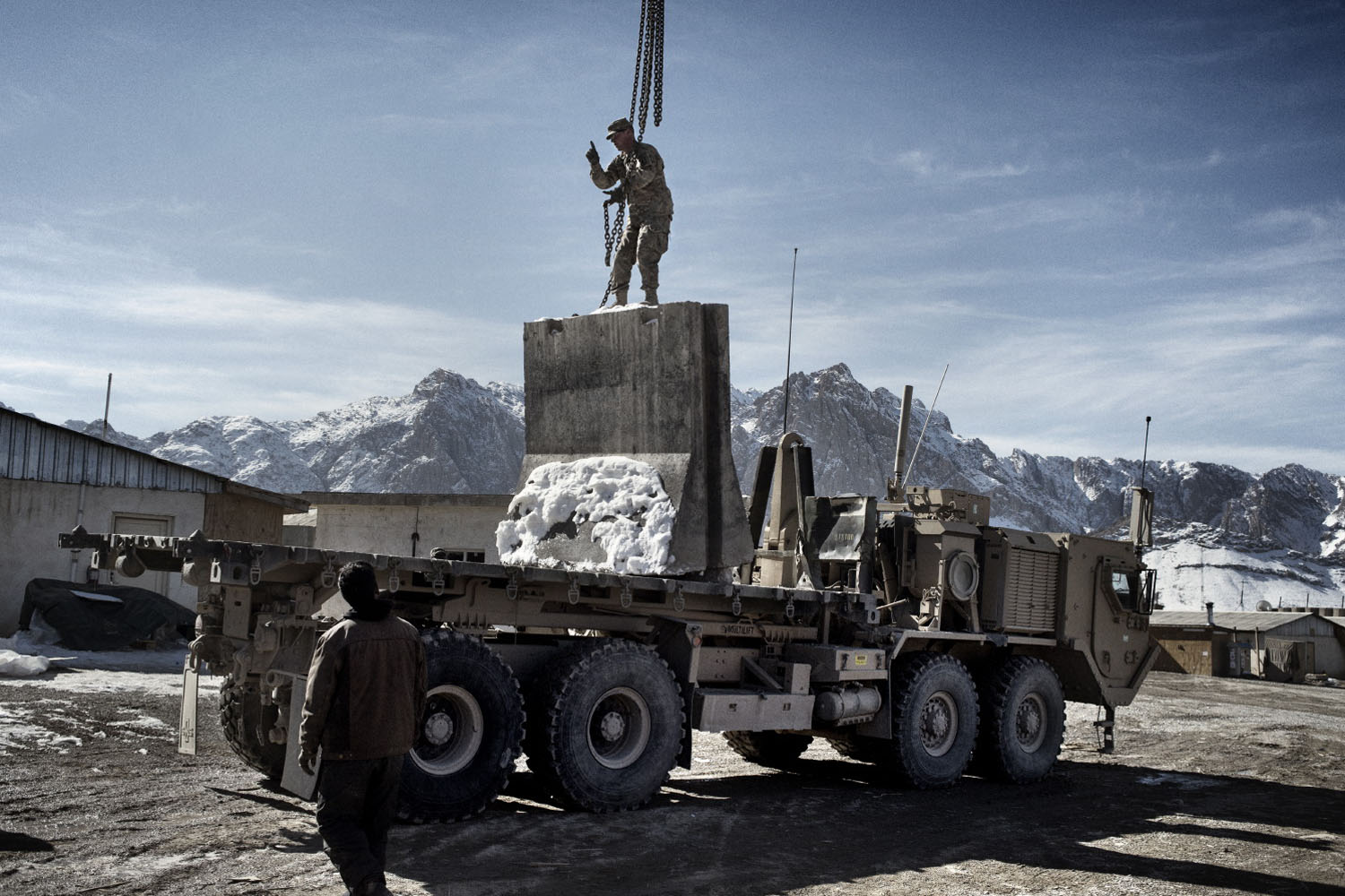 Forward Operating Base Ultimur, Logar Province, Afghanistan January 24 2013A soldier from Bull Battery, 1-319th Airborne Field Artillery Battalion loads concrete blocks on a truck in preparation for leaving Forward Operating Ultimur, Logar Province, Afghanistan. Bull Battery is returning to their base in Germany after a nine-month tour in eastern Afghanistan.