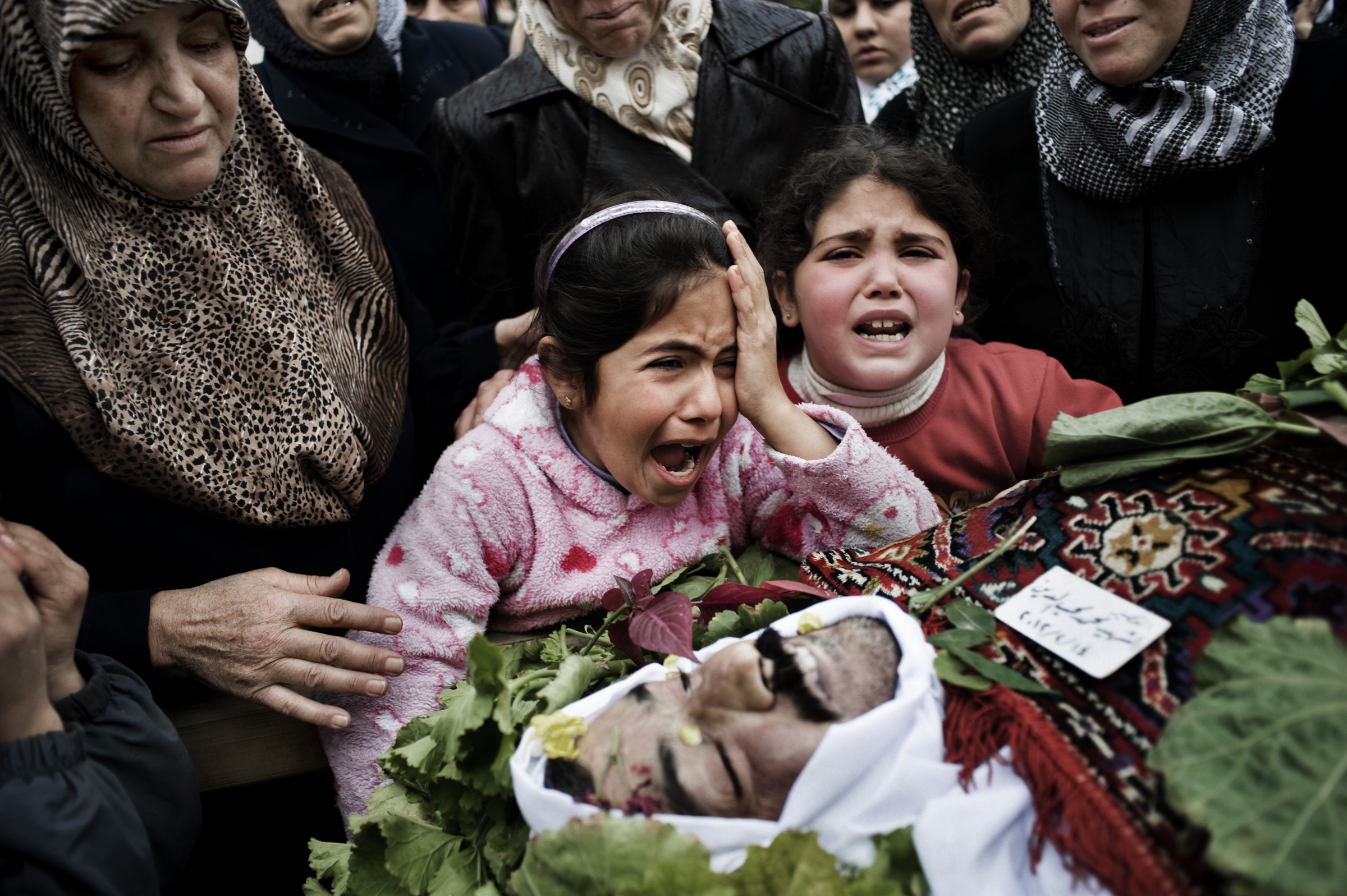 General News, 1st Prize Stories Alessio Romenzi, Italy. 14 February 2012 Al-Qusayr, Syria. A child mourns her father, who was kidnapped, tortured and killed by shabiha (government militias) with other two men. Their bodies were abandoned in a main street. The civilian unrest in the Syrian Arab Republic began in March 2011 and continues to affect people, particularly in the most vulnerable segments of the population. At least 60,000 people have been killed since uprising began, according to the United Nations (UN), and the number of Syrian refugees registered by the UN in the Middle East and North Africa has surpassed half a million. The situation continues to deteriorate in villages and cities in the country, leaving people without protection, shelter, food and water and facing fear every day.