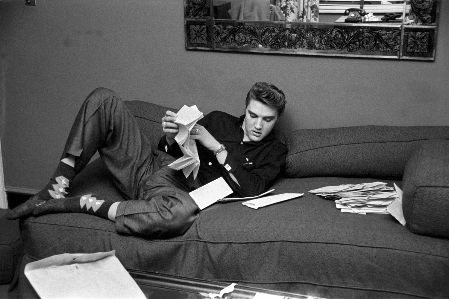 March 17, 1956. The Warwick, New York. We got into his room and there was an envelope on the couch with about a hundred letters from fans inside. He plopped down on the couch, pulled his shoes off (exposing his argyle socks) and proceeded to read some of the fan mail. Some letters were six or seven pages long and he was going to read every page. After he finished reading them, he tore them up, explaining  I don't want anyone else reading my mail and I'm not taking it with me.