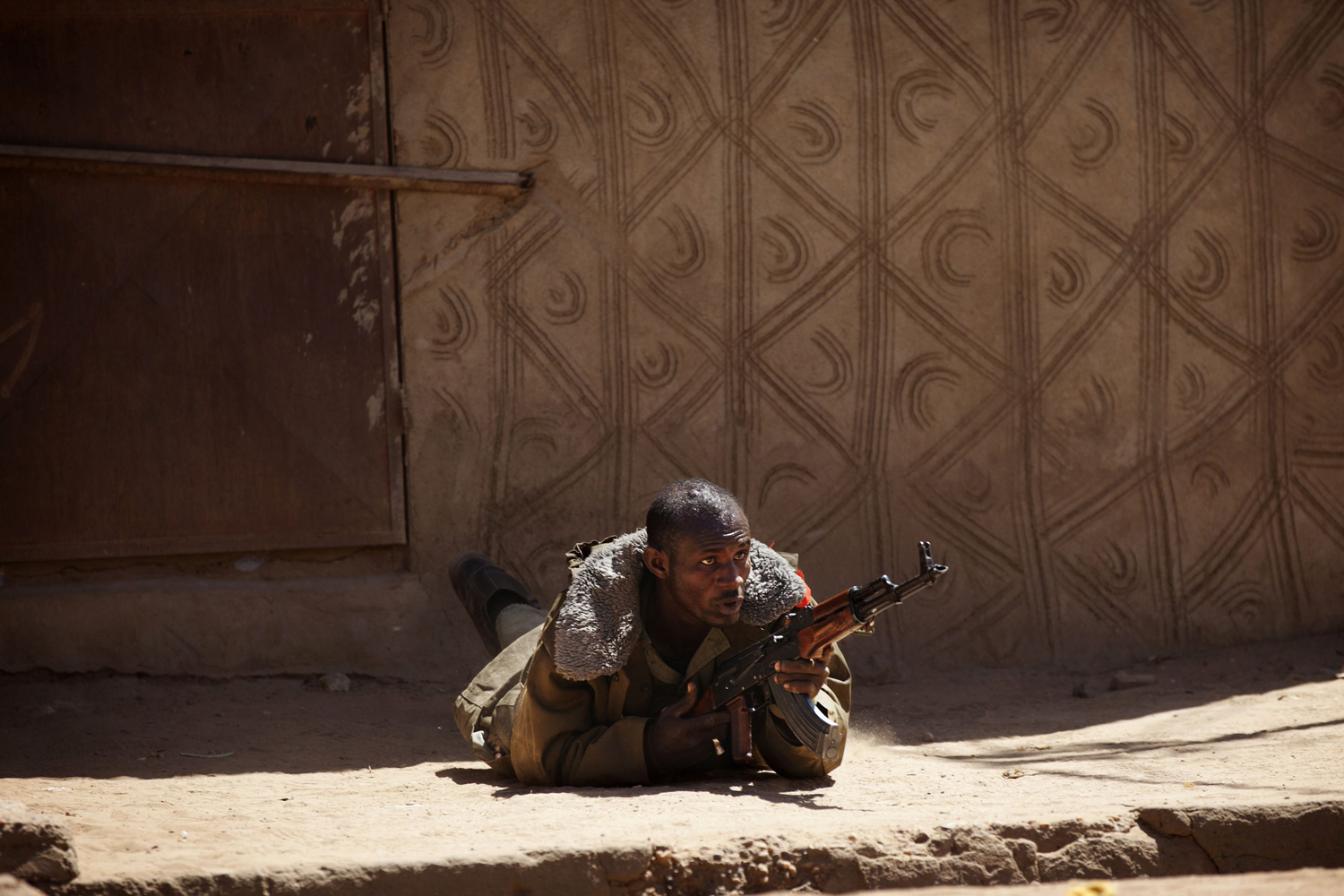 A Malian soldier fires an AK-47 during fighting with Islamists in Gao