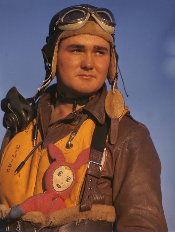 American bomber crew member with stuffed good-luck charm during World War II, England, 1942.