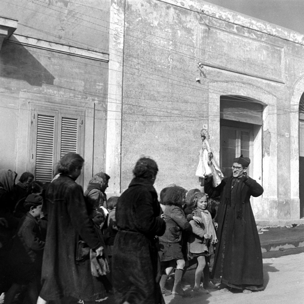 Priest and children during the 1944 eruption of Mt. Vesuvius, Italy.
