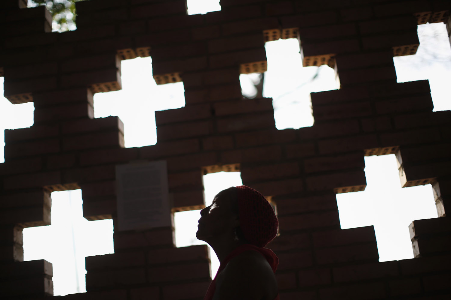 A supporter of Venezuelan President Chavez prays in chapel outside military hospital in Caracas