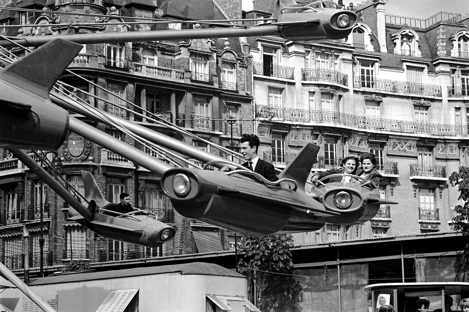 Parisians enjoying an amusement park ride, 1963.