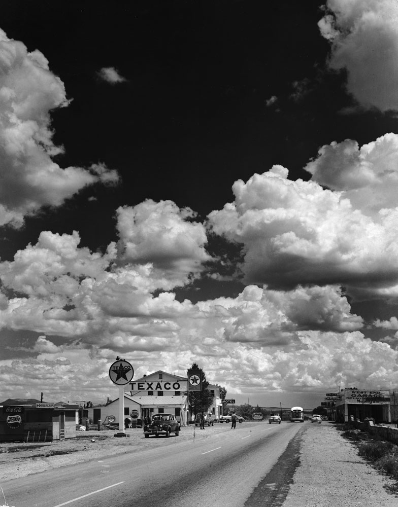 Dramatic cumulus clouds billow above a Texaco gas station along a stretch of Route 66 in Arizona, 1947.