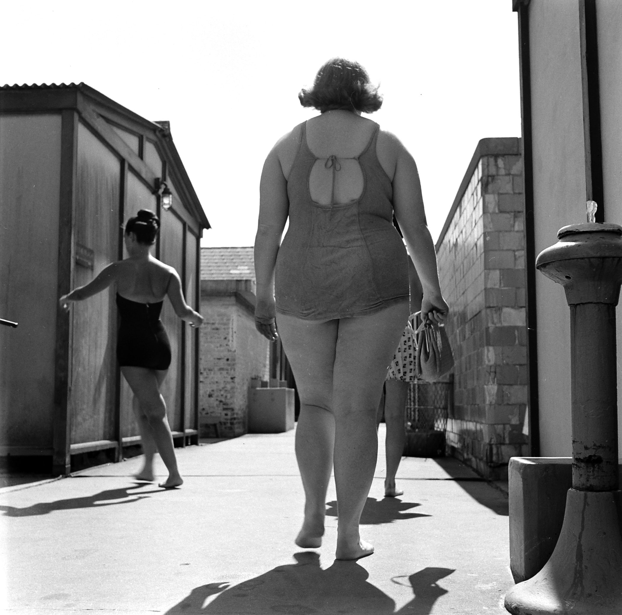 Bulging at beach in 1949, 197-pound Dorothy [Bradley] self-consciously leaves locker room for swim. She covered up embarrassment by being jolly and gregarious