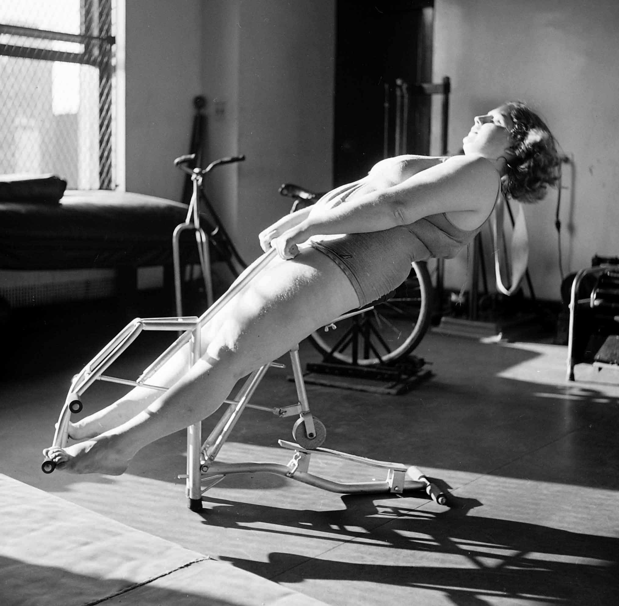 Dorothy Bradley, photographed for LIFE magazine article on obesity, works out in 1949.