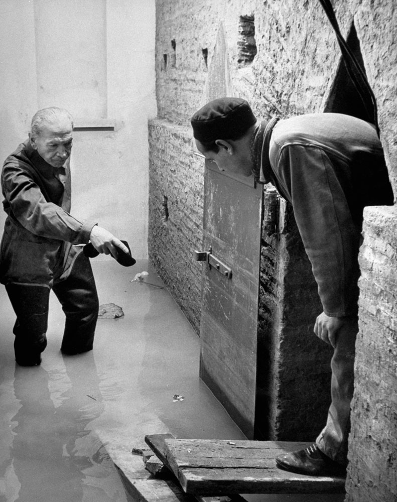 Workers gauge damage from water seepage during the excavation beneath St. Peter's in Rome, 1950.