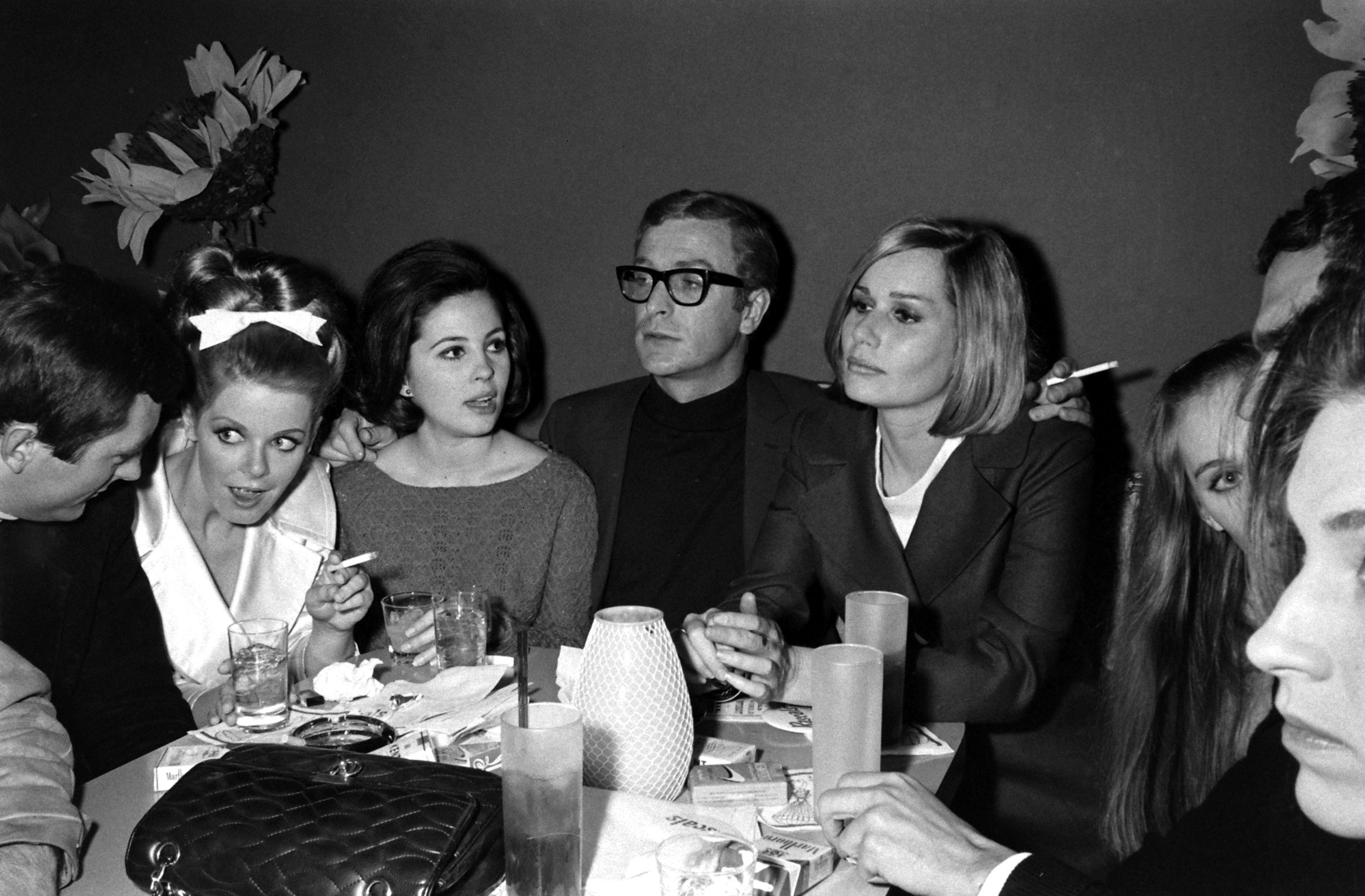 Michael Caine with friends, including the actress Sally Kellerman (on his left), in Los Angeles in 1966.
