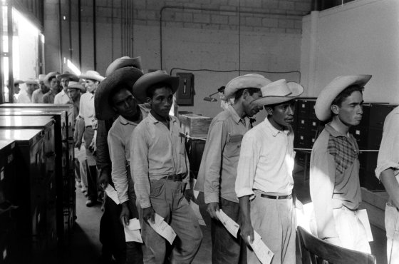 Mexican migrant farm workers at reception center in Hidalgo, Texas, line up for job interviews, 1959.
