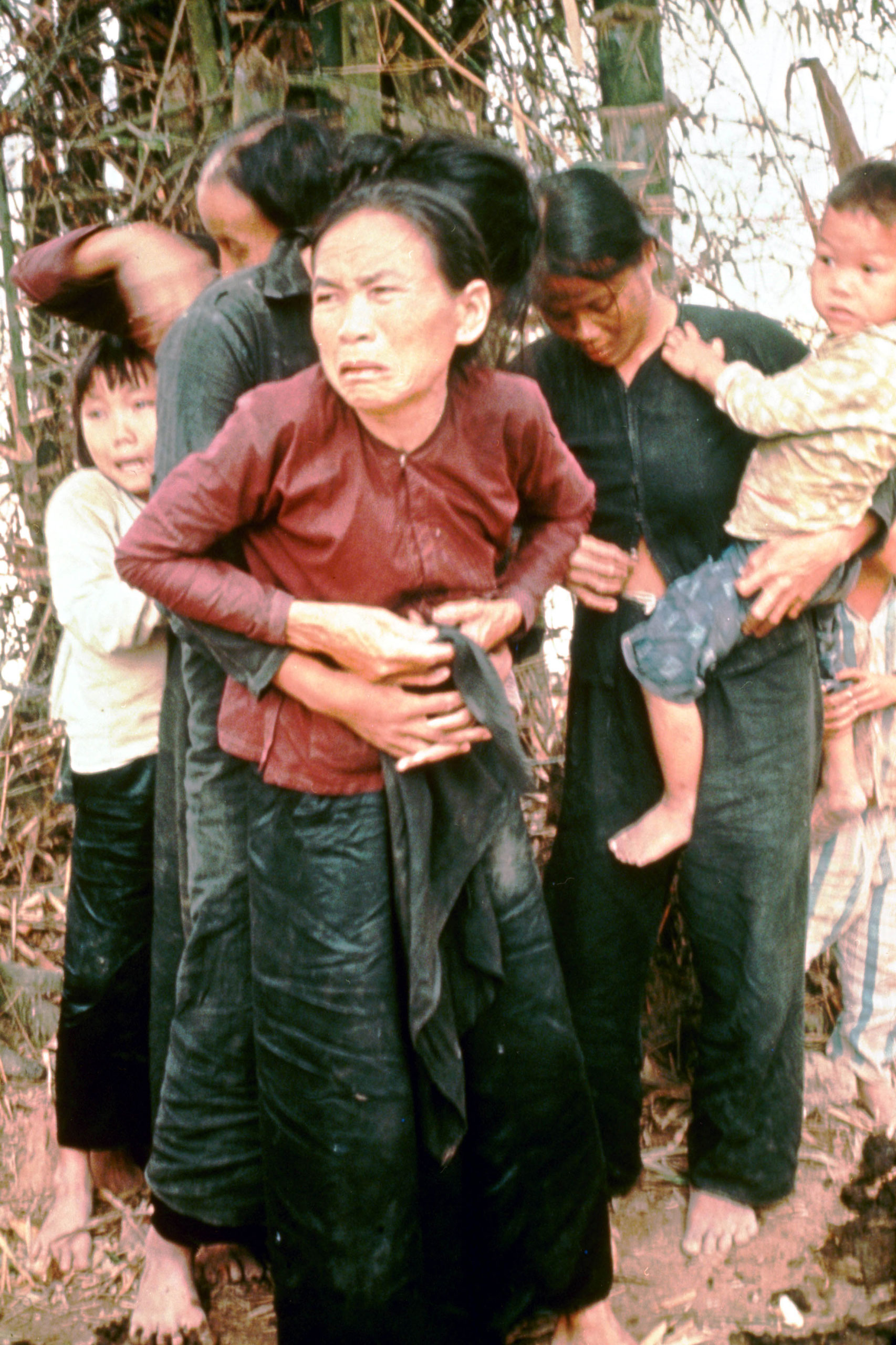 A group of women and children huddle in terror moments before being murdered by American troops in the village of My Lai, Vietnam, March 16, 1968.
