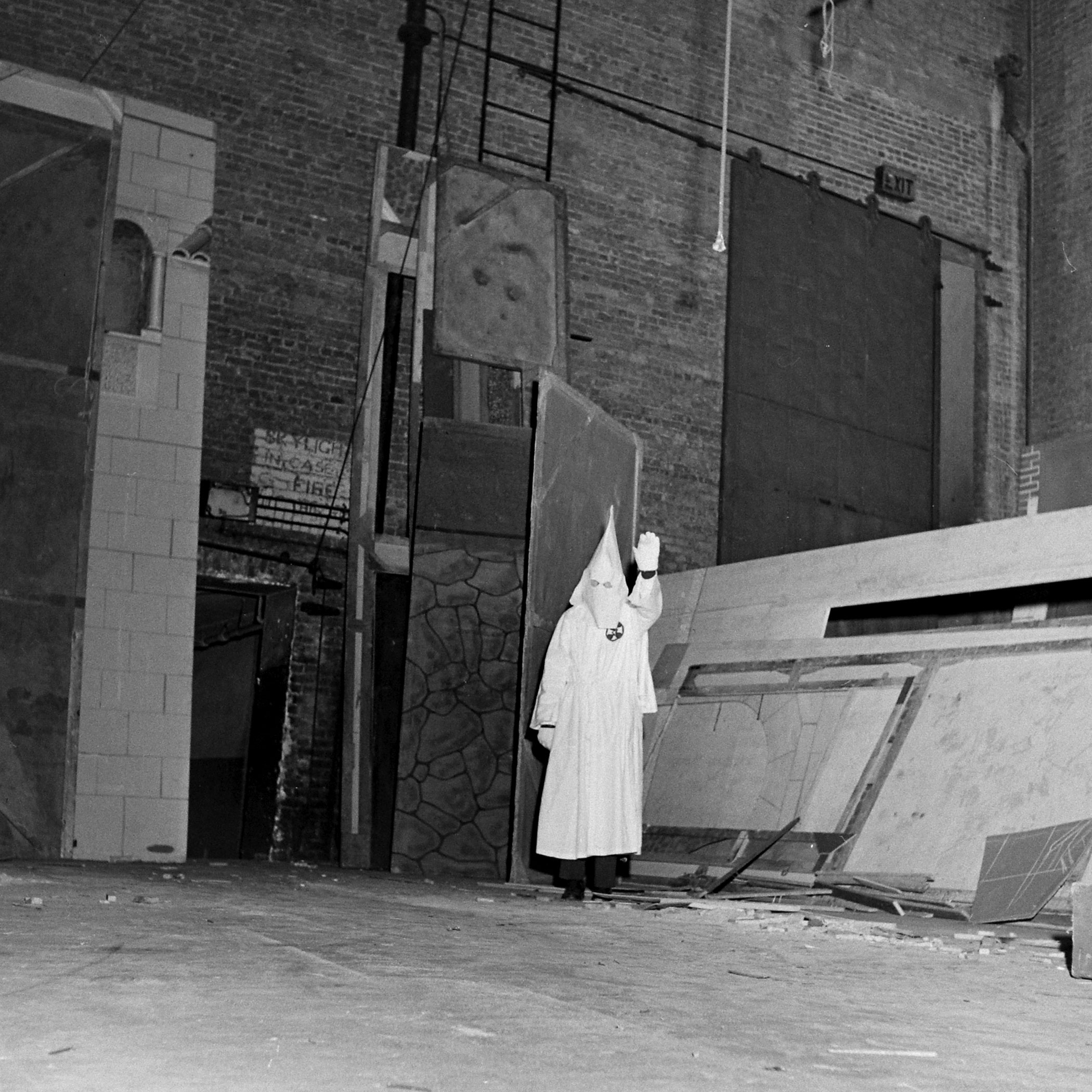 A Ku Klux Klan member demonstrates ritualistic aspects of a KKK meeting, Georgia, May 1946.
