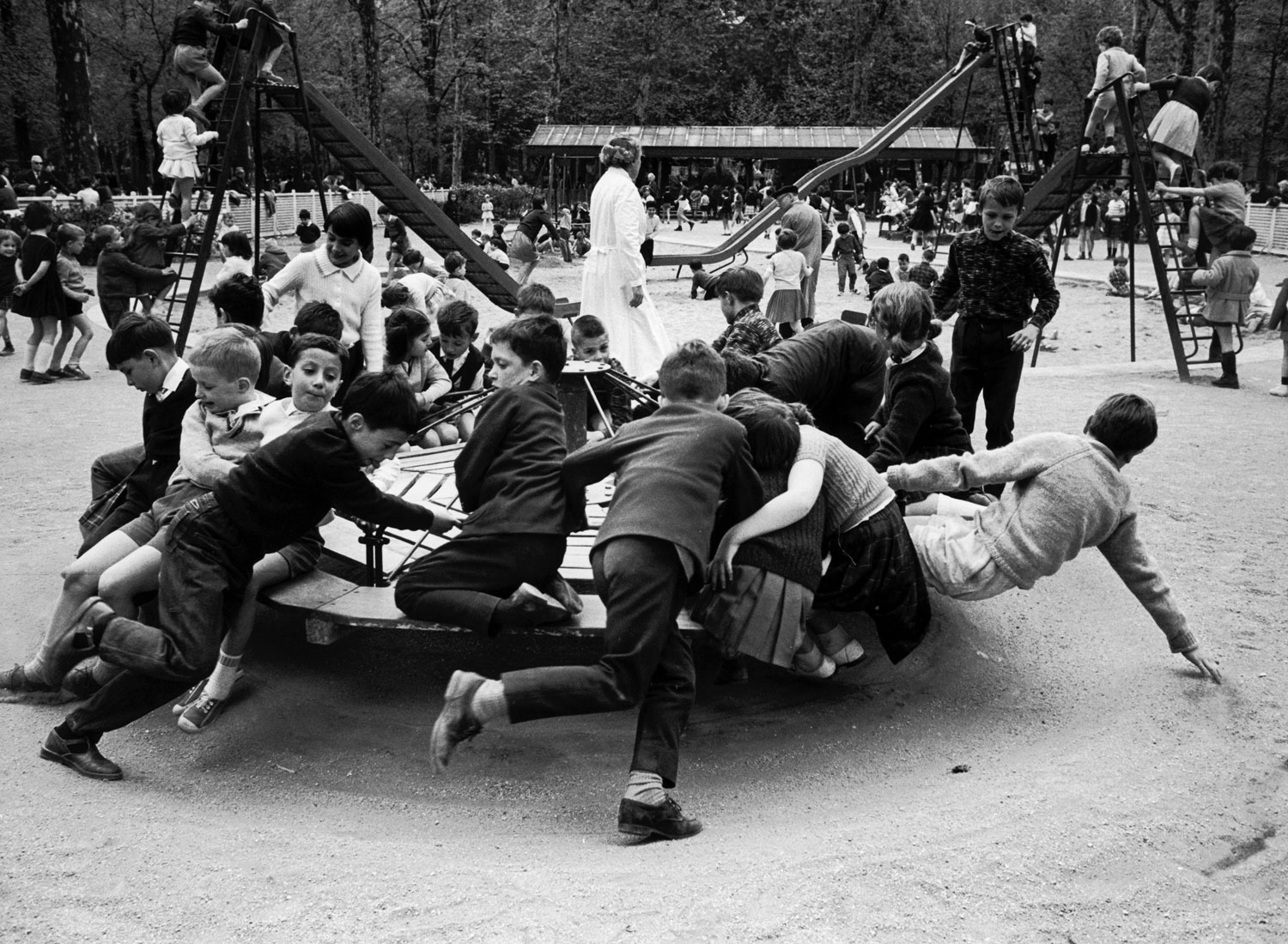 Parisian children riding merry-go-round in a playground, 1963.