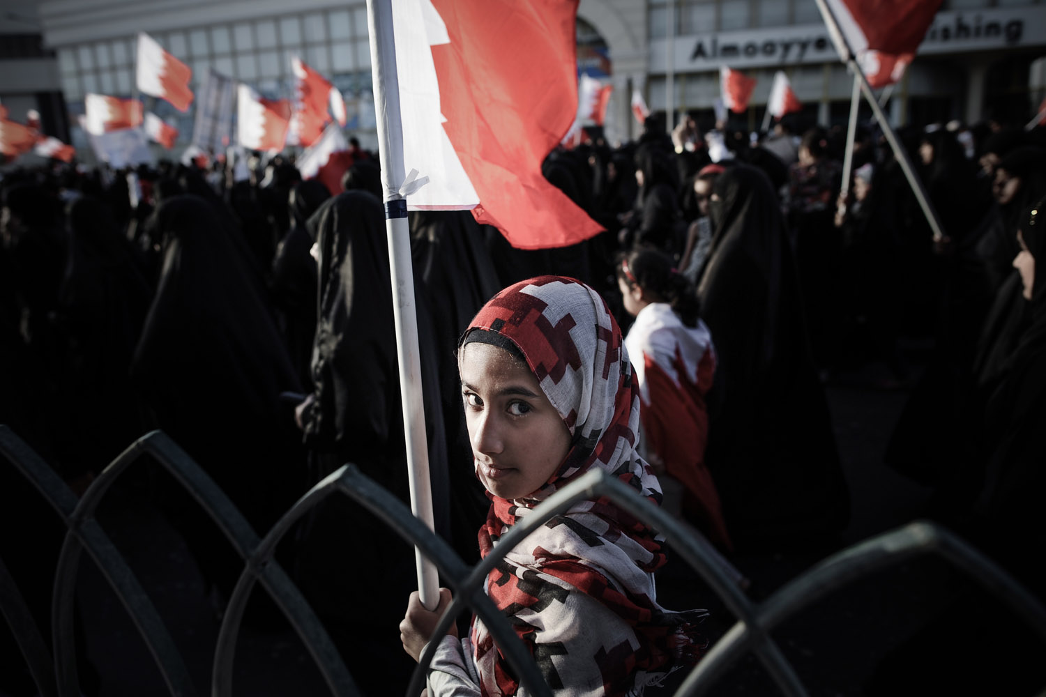 March 22, 2013. A Bahraini girl holds a national flag during an anti-government rally in solidarity with jailed human rights activist, Nabeel Rajab in the village of Belad Al Qadeem, in a suburb of Manama. The International Federation for Human Rights says around 80 people have been killed in Bahrain since violence first broke out on February 14, 2011 when thousands of protesters camped out in Manama's Pearl Square, taking their cue from the Arab Spring uprisings.