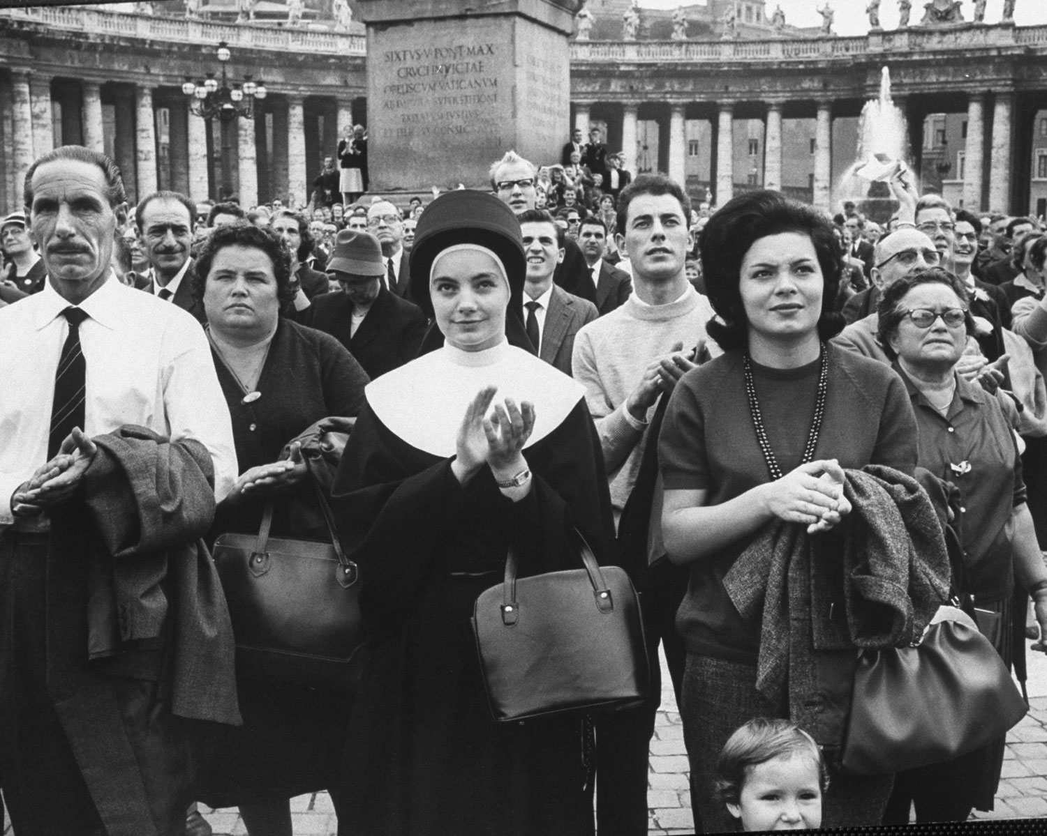 Devout observers of procession of Catholic prelates entering St. Peter's during the Second Vatican Ecumenical Council, 1962.