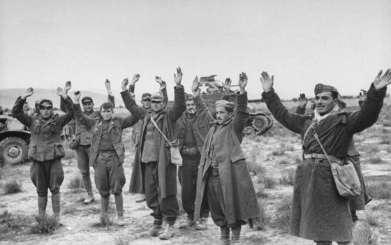 A group of Axis prisoners are taken during the Allied assault on German positions near Sened, Tunisia, 1943.