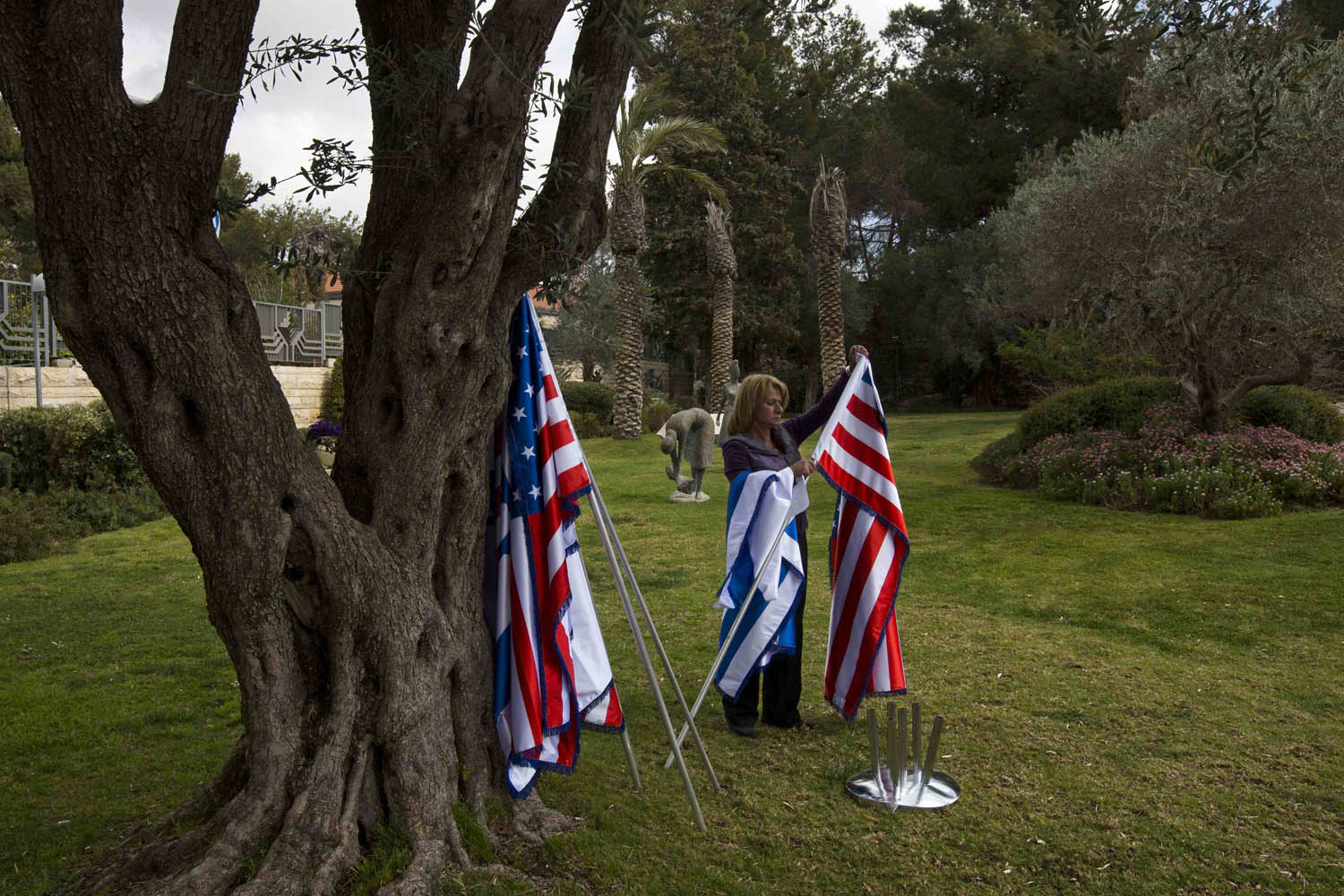 An employee arranges flags at the residence of Israel's President in Jerusalem