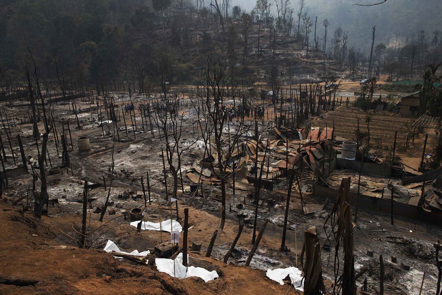 March 23, 2013. Body bags cover charred bodies of victims of a fire at the burnt Ban Mae Surin refugee camp near Mae Hong Son. At least 42 people have died in a fire at a camp which is home to thousands of refugees from Myanmar near the Thai-Myanmar border on Friday, local media reported.