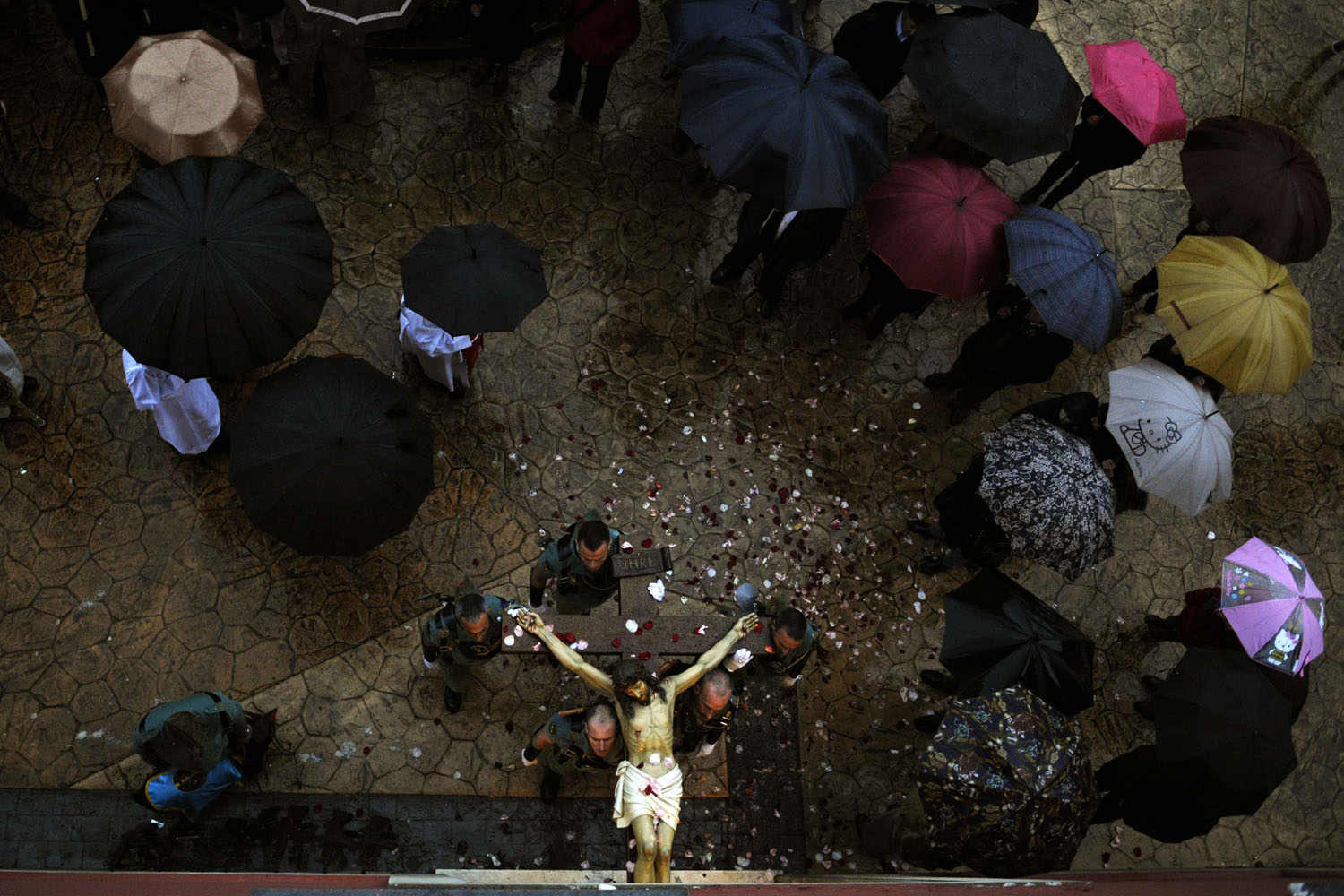 March 24, 2013. Spanish legionnaires carry a statue of the Christ of the Mercy into the church after the Palm Sunday procession of the  Estudiantes  brotherhood was suspended due to rain at the start of Holy Week in Oviedo, northern Spain.