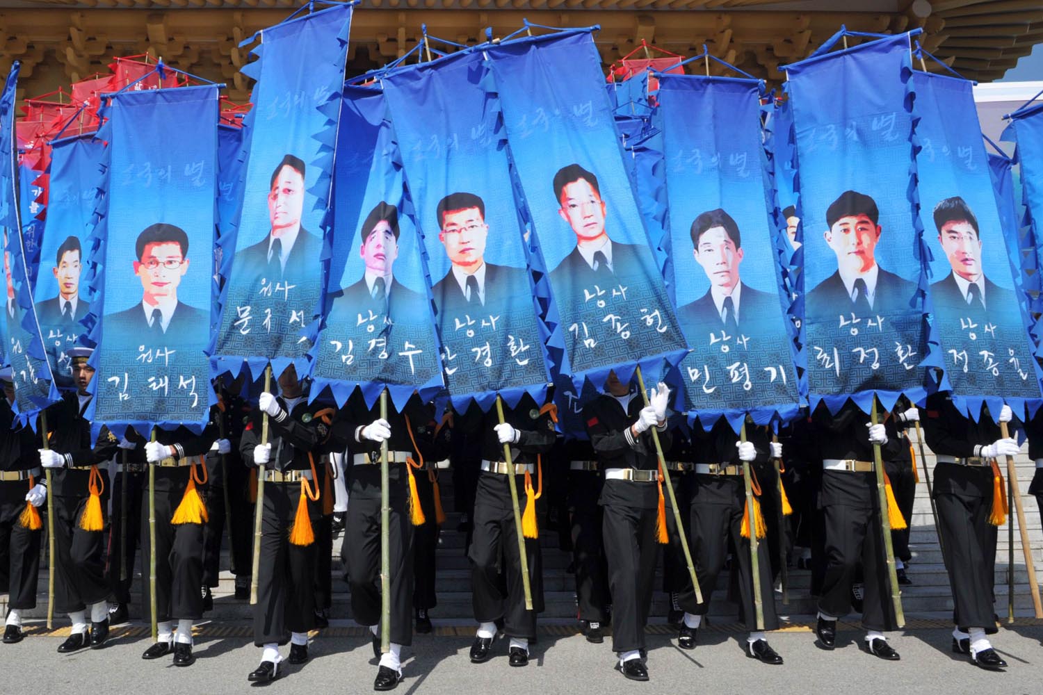 March 26, 2013. South Korean honour guards hold banners with pictures of the sailors who died in the sinking of a South Korean naval vessel by what Seoul insists was a North Korean submarine, during an event marking the third anniversary of the incident, at the national cemetery in Daejeon. Forty-six sailors died when the Cheonan corvette sunk.