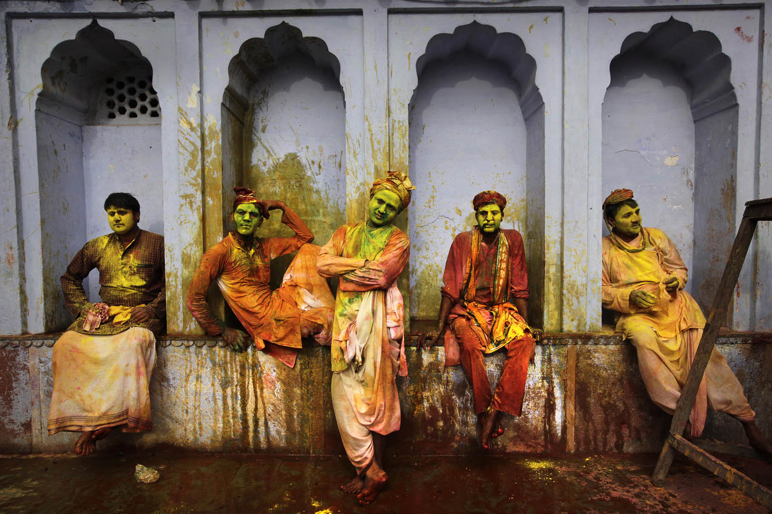 March 22, 2013. Indian villagers from Nandgaon wait for the arrival of villagers from Barsana to play Lathmar Holi at the Nandagram temple in Nandgaon, India.