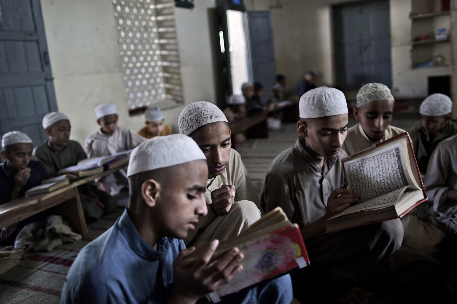 March 26, 2013. Pakistani students of a madrassa, or Islamic school, recite verses of the holy Quran, in Islamabad, Pakistan.