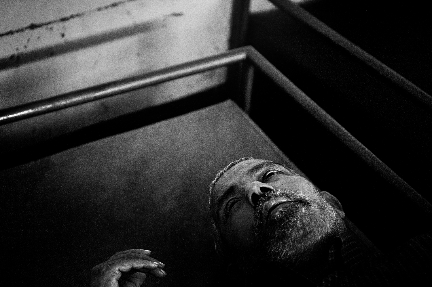 A patient suffering from suspected mental illness on his cot, inside a center run by volunteers in Thodupuzha, Kerala. In the state, the assistance for alcoholics, orphans and the alleged mentally ill is for the most part entrusted to voluntary organizations, with very limited resources.