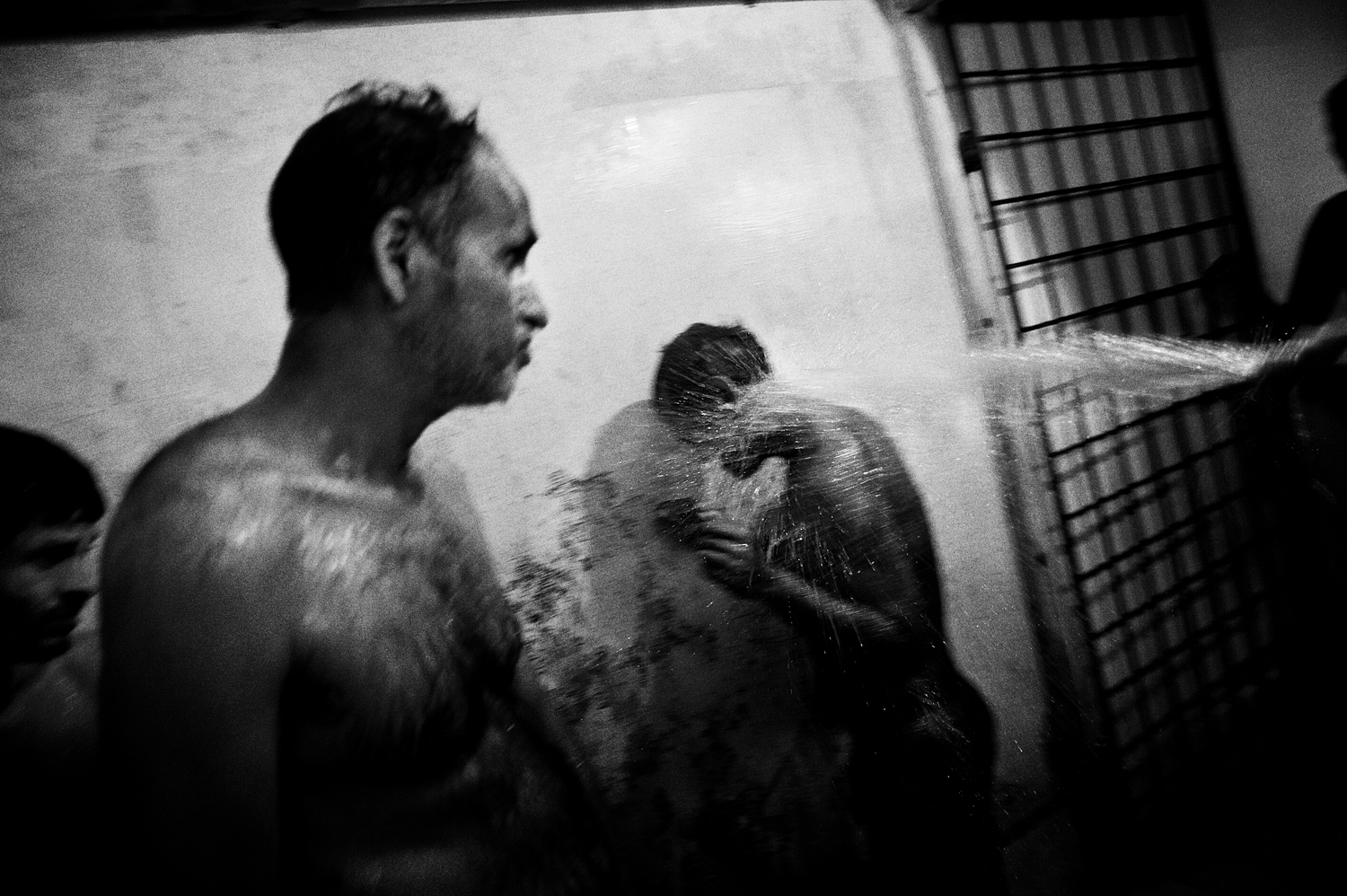 Patients suffering from suspected mental disorders in the showers, in a center run by volunteers in the town of Thodupuzha.