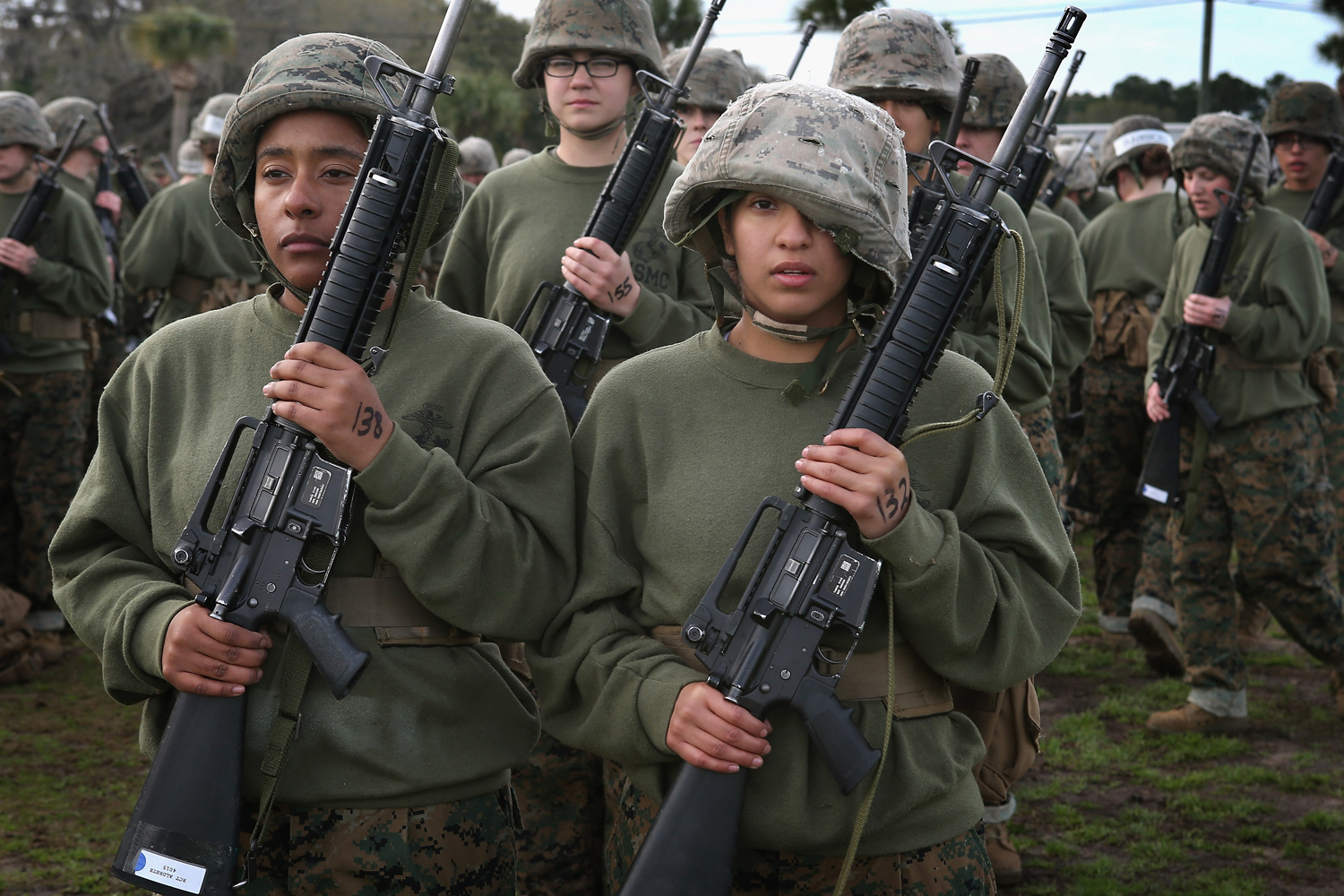 Feb. 27, 2013. Female Marine recruits Princesse Aldrete (L) and Genisis Ordonez (R) stand in formation following hand-to-hand combat training during boot camp at MCRD Parris Island, South Carolina.