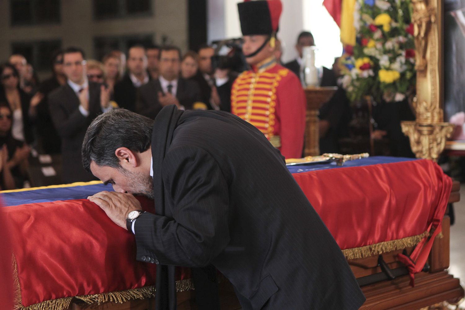 Iran's President Mahmoud Ahmadinejad pays tribute to late Venezuelan President Hugo Chavez in Caracas