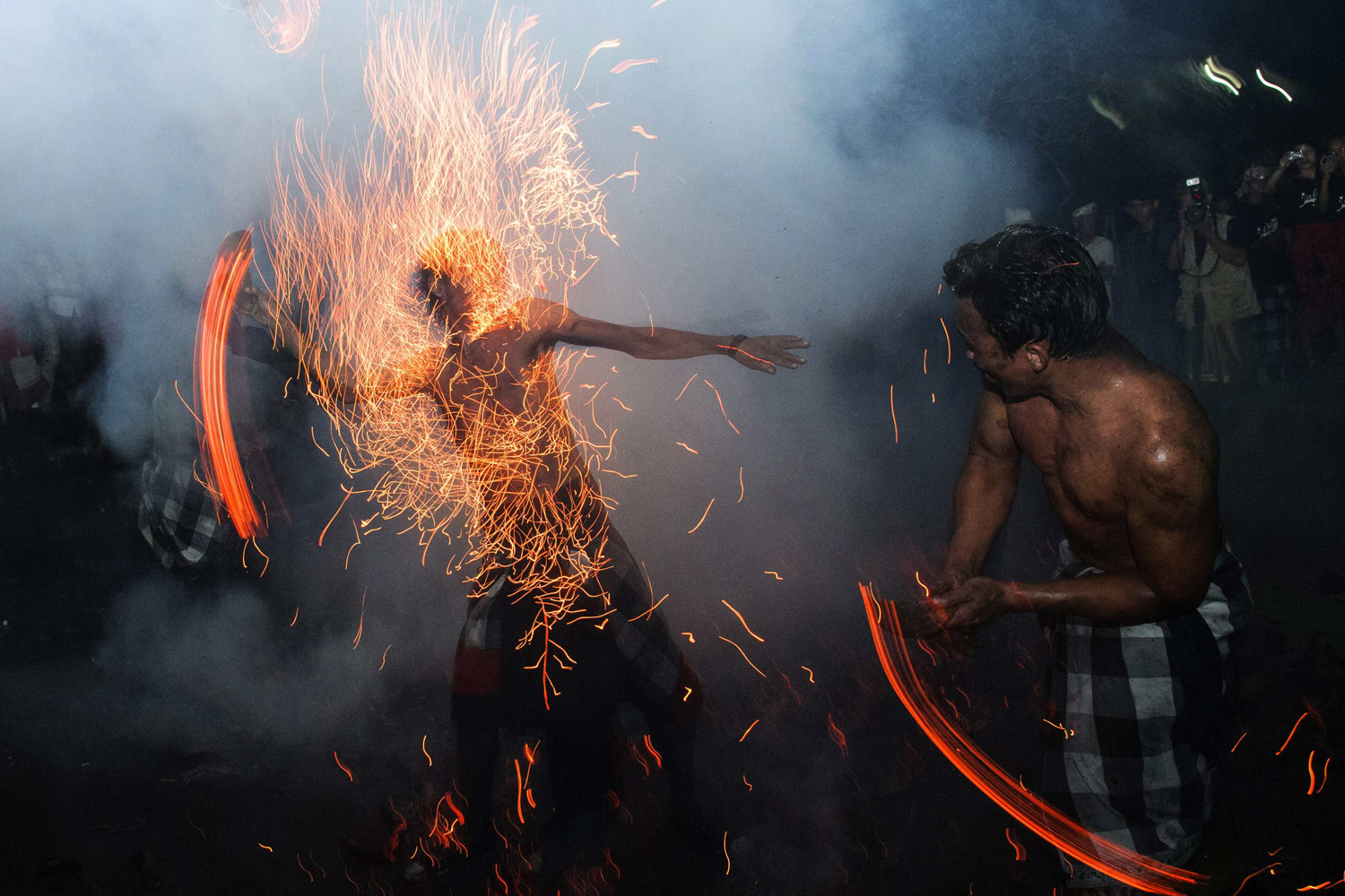 Balinese hit each other with fire during the "Perang Api" ritual ahead of Nyepi day in Gianyar, Bali