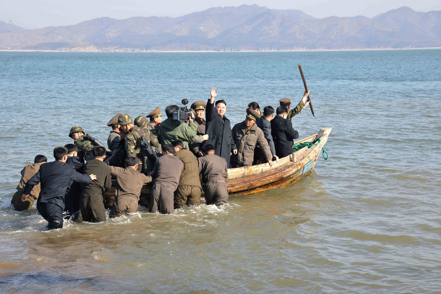 North Korean leader Kim Jong-Un waves while in a boat during his visit to the Wolnae Islet Defence Detachment in the western sector of the front line, which is near Baengnyeong Island of South Korea