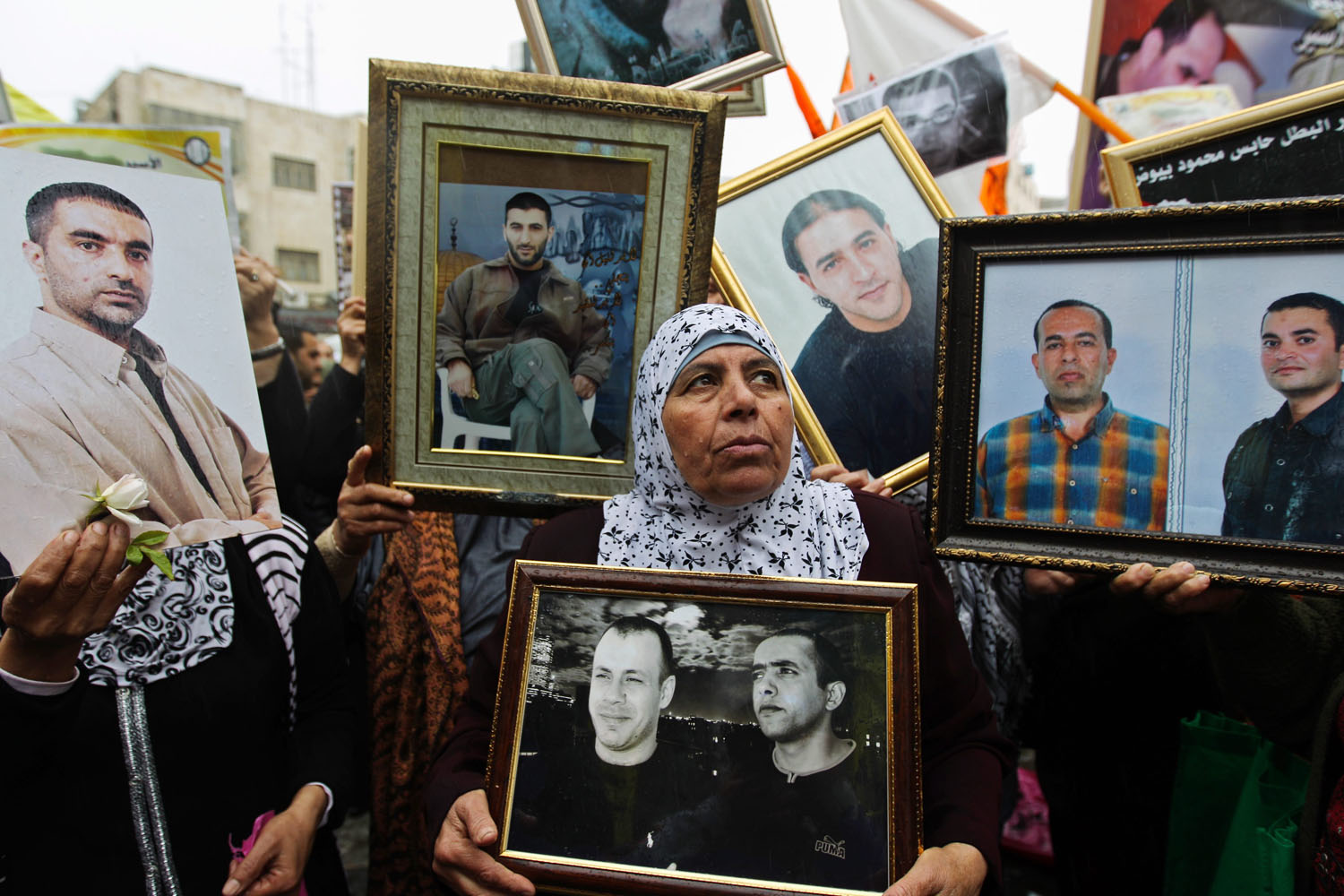 April 17, 2013. Palestinians carry portraits of prisoners while attending a rally to highlight the situation of some 4700 Palestinians currently jailed in Israel during a rally on the annual Palestinian Prisoners' Day in the West Bank city of Ramallah.