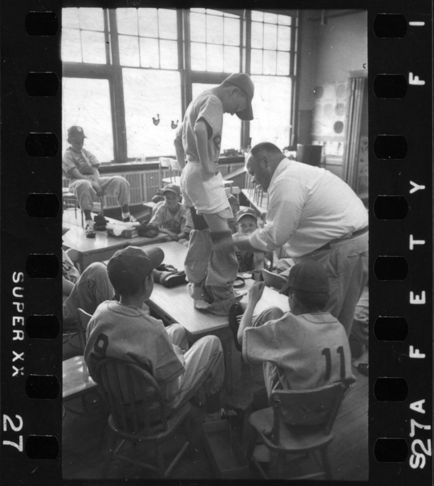 Players putting on uniforms during the 1954 Manchester, New Hampshire, Little League season.