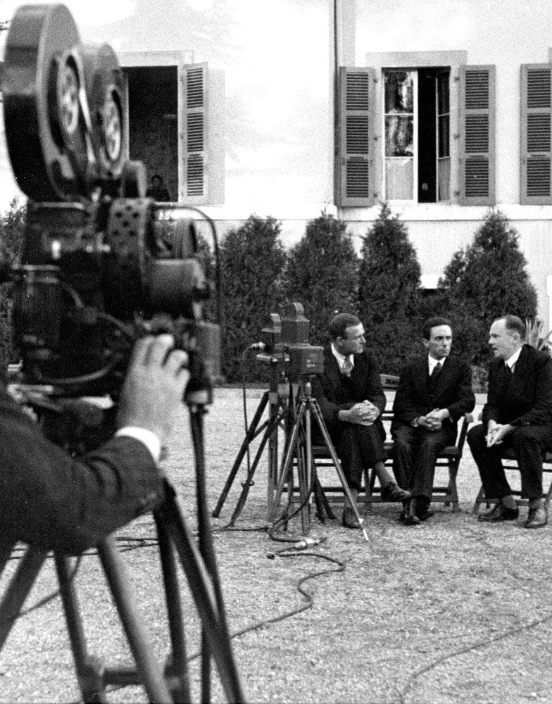 Joseph Goebbels (center) with unidentified men in garden of the Carlton Hotel before delivering a radio address, Geneva, September 1933.