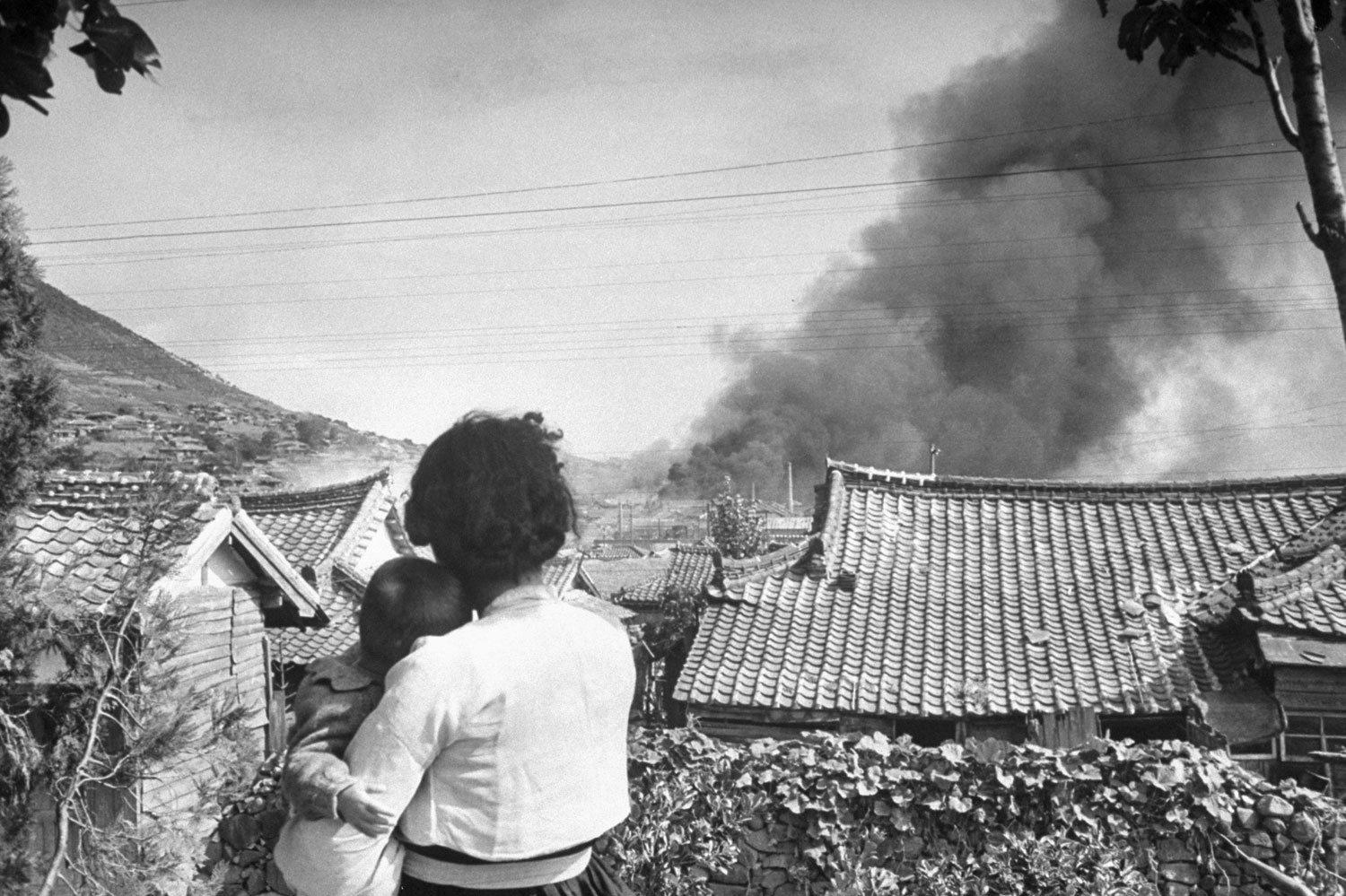 Large fires in a village during a communist uprising, Korea, 1948.