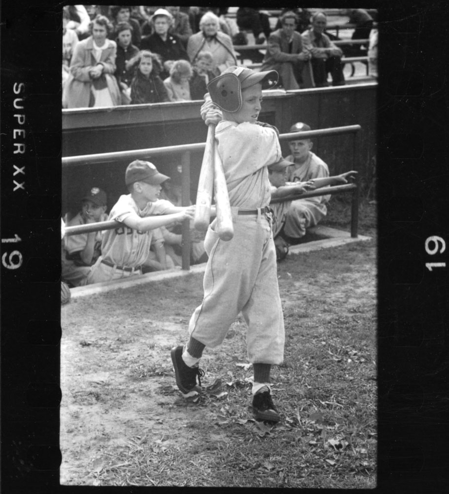 A New Hampshire Little Leaguer warms up before an at-bat, 1954.