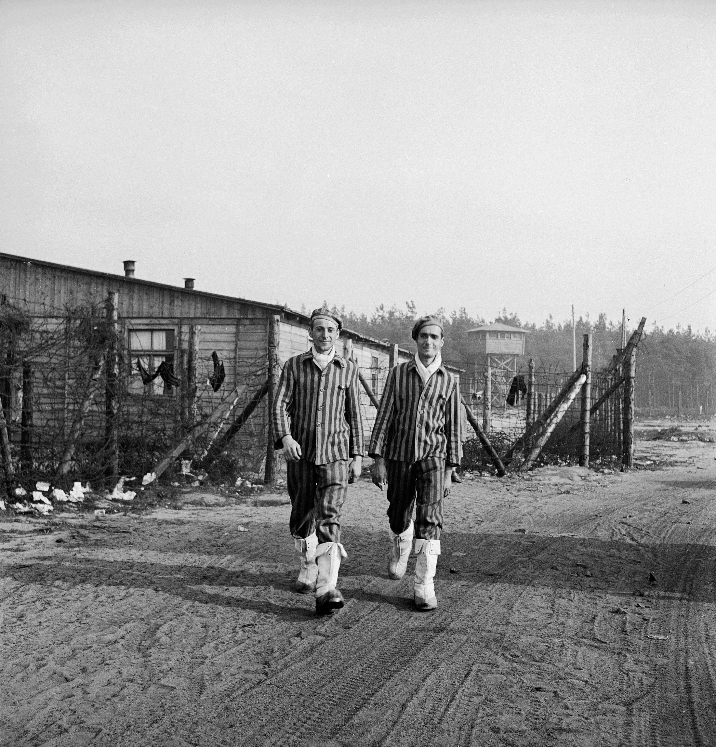 New internees of the freshly liberated Bergen-Belsen concentration camp included this pair of French brothers, Charles and Louis Perret, wearing white boots they took from the Germans, 1945.